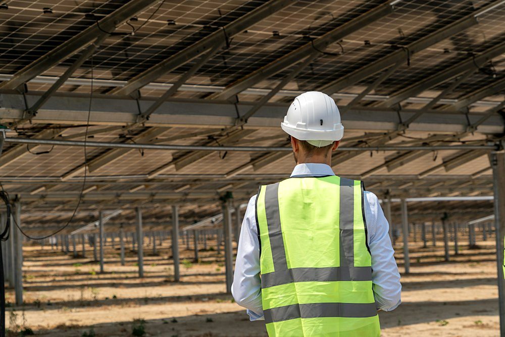Engineer walking the rows of a solar plant